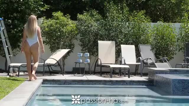 Blonde bombshell in white thong bikini struts by poolside
