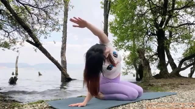 ZhouYiQin in tight purple leggings doing yoga by river, busty ass view