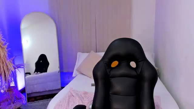 Blonde bombshell in gaming chair, teasing pose for spoiled darling fans