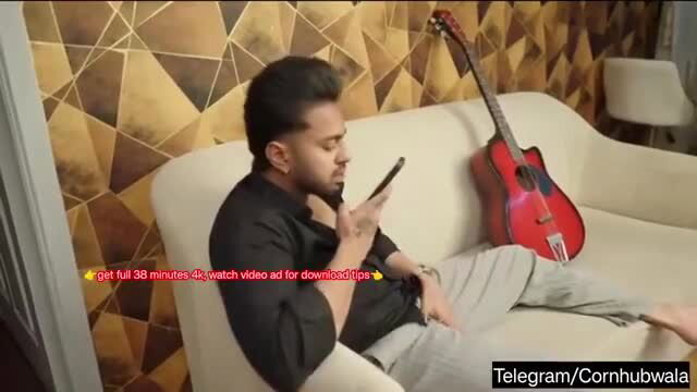 Resmi R Nair sexy lounging pose on sofa in black shirt