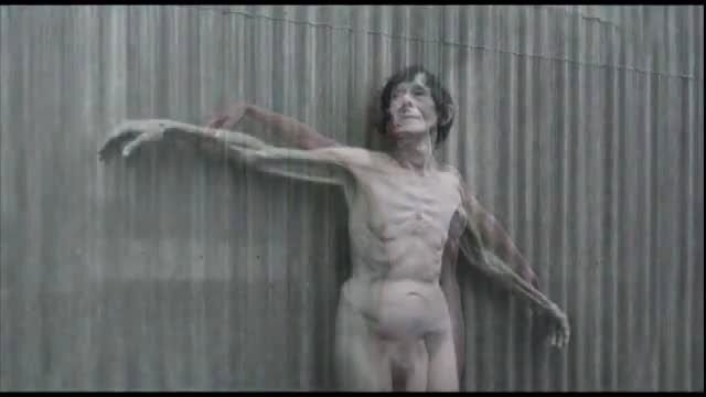 Naked woman on a wall in the rain