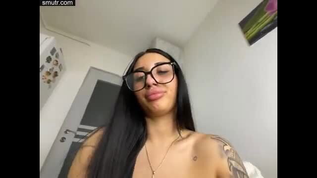 Latina BBW with huge natural tits squeezing them in glasses closeup