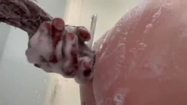 Stepdad's hand with razor shaving soapy stepdaughter's plump ass in shower