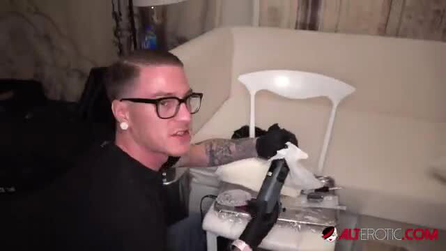 AltErotic tattooed guy in glasses prepping with drill and rag for kinky play