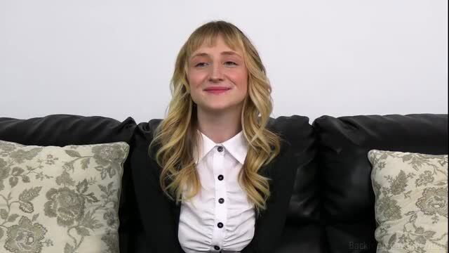 Pixie Lovely blonde bangs smiling on Backroom Casting Couch couch