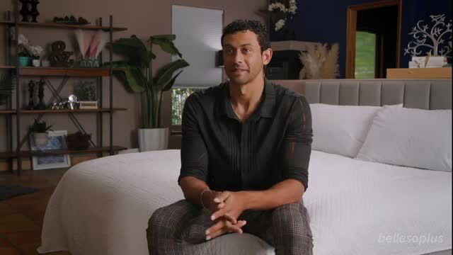 Ryan Conner sits on bed in stylish bedroom interview