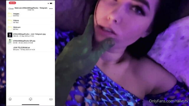 Brunette OnlyFans girl teases lips with hand in fishnet top