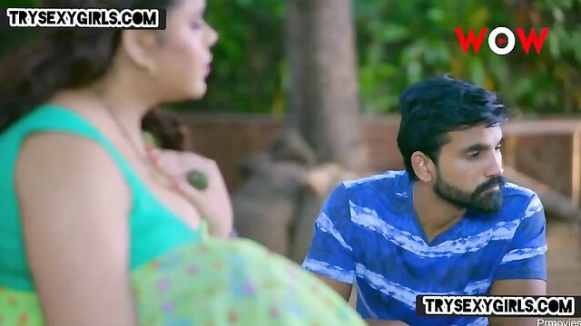 Hot Indian bhabhi in green saree teases with cleavage near hunk in beach scene