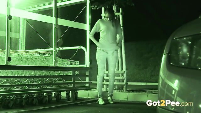 Night vision amateur girl pissing pants in public parking lot