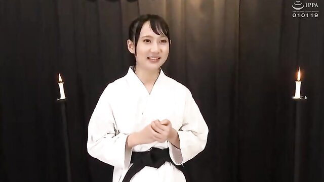 Japanese JAV girl in white gi karate uniform smiling softly