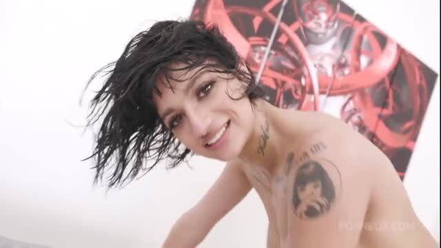 Wet tattooed brunette smiling topless in steamy closeup