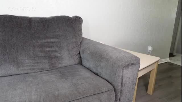 Jecca Jacobs in empty living room couch scene