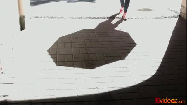 Sofi Goldfinger red heels casting octagonal shadow on pavement