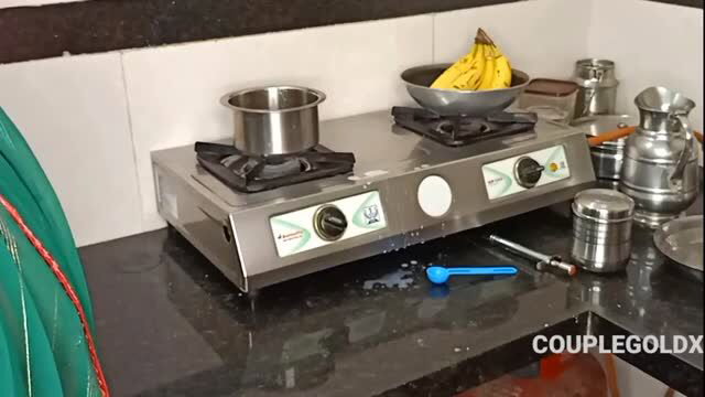 Komal's Indian kitchen with stove, pots, bananas, tea setup