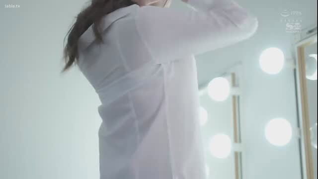Asian woman in sheer white blouse at vanity mirror, softcore tease