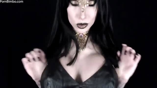 Miss Emily Astrom goth beauty in gold necklace and black cleavage dress