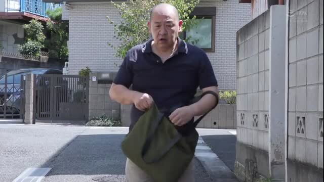 Bald Japanese man holding green bag outside house, JAV thumbnail