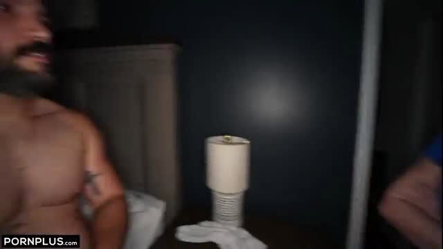 Bearded muscular man laughing naked in bedroom scene