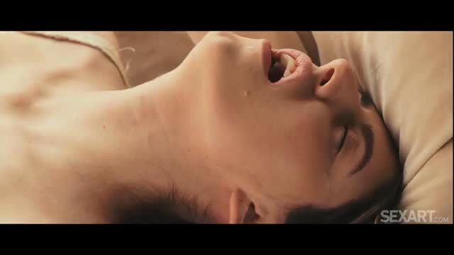 Fanta Sie lying nude in ecstasy on bed, closeup face and neck