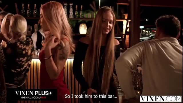 Dolly Orchid chats at bar with blonde & brunette in bar scene