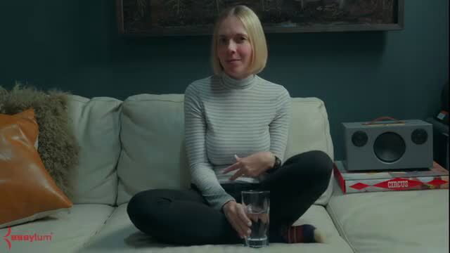 Rebel Rhyder in turtleneck and leggings on couch at Assylum