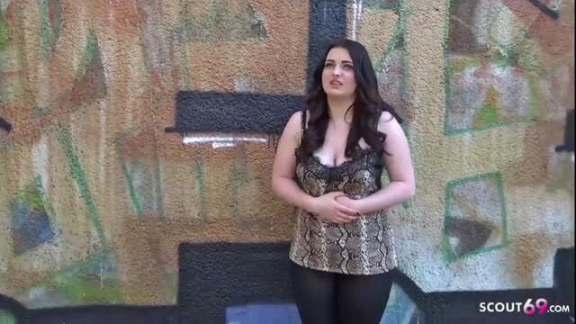 Aaliyah Grey in snakeskin top and leather pants by graffiti wall