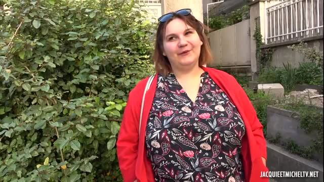 Curvy brunette BBW MILF in floral dress smiling outdoors