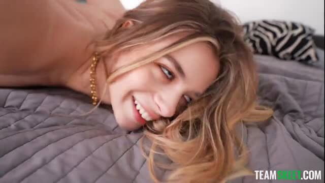 Molly Little topless blonde teen smiling on bed, sexy pose