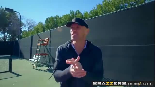 Man gesturing on tennis court in Lily Love Brazzers teaser