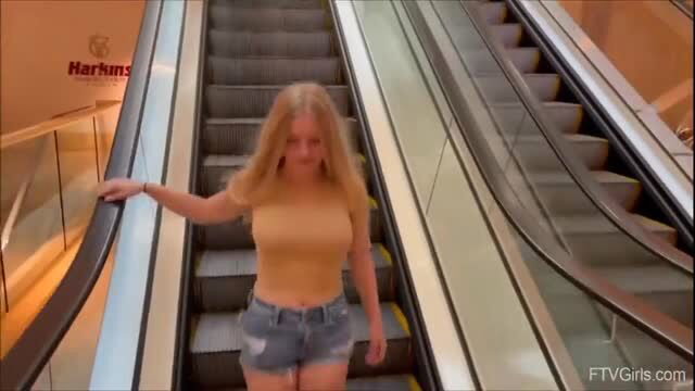 Busty blonde Kylie Shay in tight top and daisy dukes on escalator