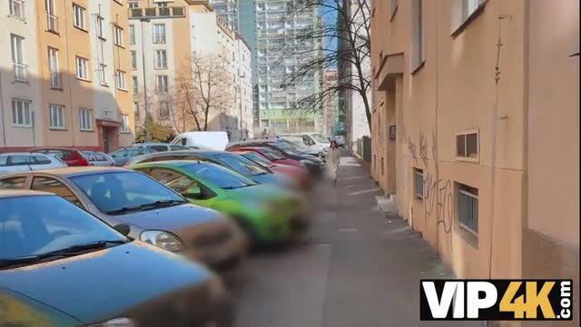 Urban street parking lot with parked cars in sunny European city
