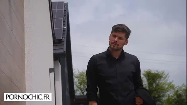 Nata Ocean's partner in black shirt outside modern home with solar panels