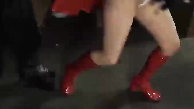 Superheroine in red boots and skirt runs in public disgrace scene