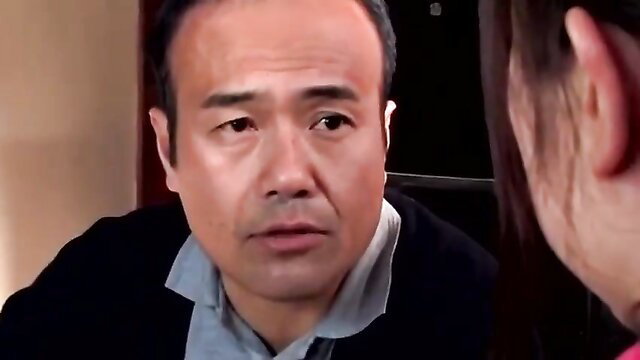 Asian man in suit chats intimately with long-haired woman in pink top