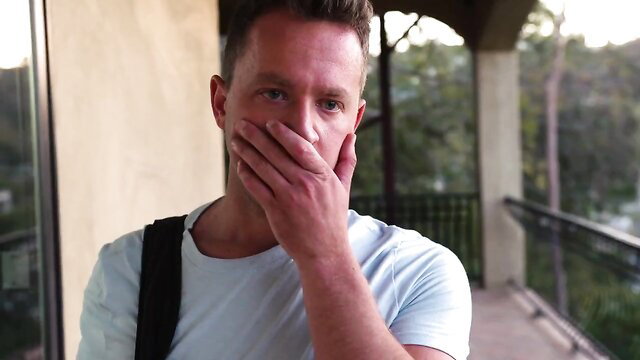Violet Myers hand over mouth on balcony, teasing expression