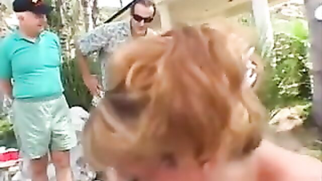 Tall blonde Lizzy Law with two men outdoors in casual shirts shorts