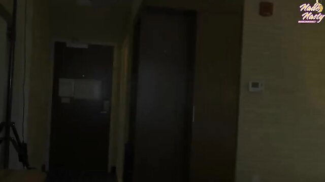 Dark hotel hallway with doors, low light, amateur ebony tease setup