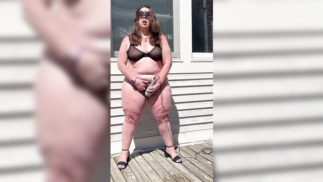 Curvy BBW wife in sheer bra and thong on deck, teasing outdoors