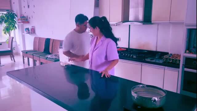 Sandra Otterson in purple scrubs with Ally in kitchen, flirty help scene