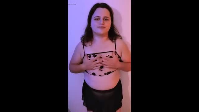 Chubby brunette in sheer lingerie posing hands on chest