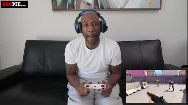 Isabella Jules gaming in white tee and sweats on couch