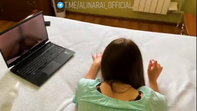 Brunette stepmom in tank top on bed typing on laptop, taboo tease