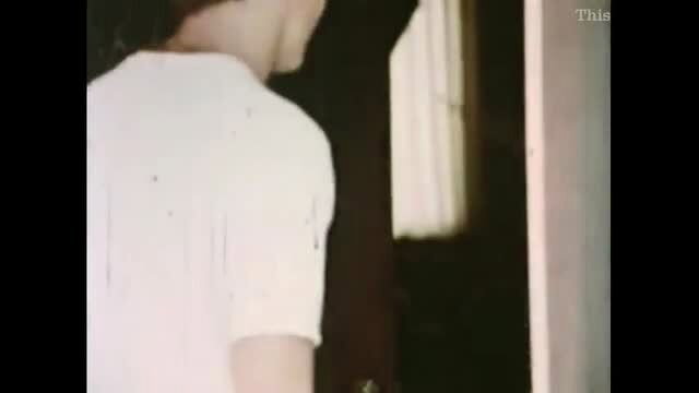 Slim Asian man in white tank top from behind in Black Over White scene