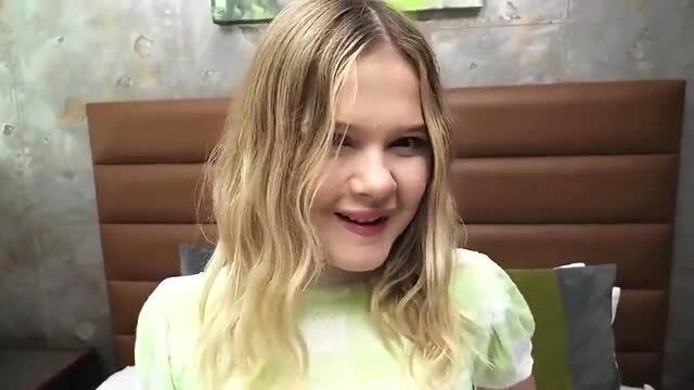 Cute 18yo blonde model smiling in green top with massive tits