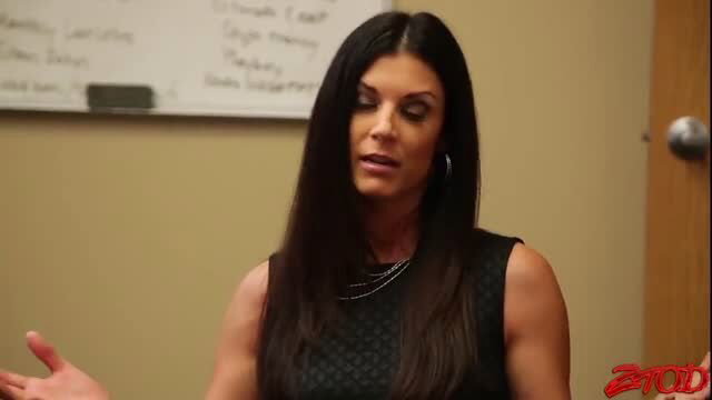 Hot brunette MILF in sexy black halter top gesturing passionately