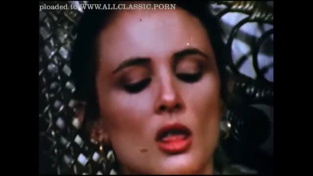 Closeup of seductive brunette woman with glossy lips in erotic gaze