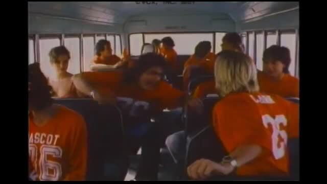 Vintage 1980s high school jocks in orange mascot jerseys cram crowded bus in classic porn