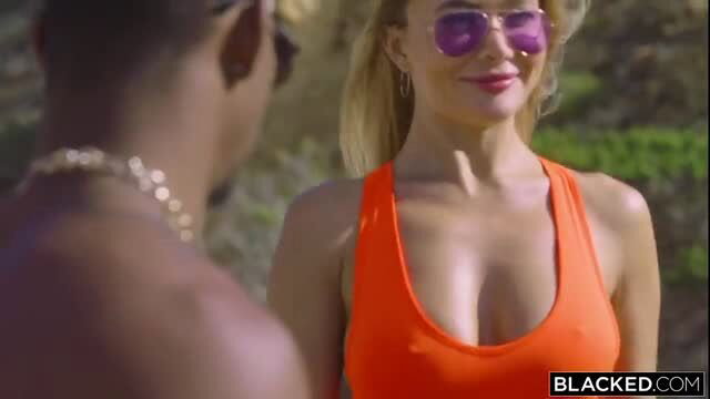 Venera Maxima in orange tank top with black stud outdoors Blacked