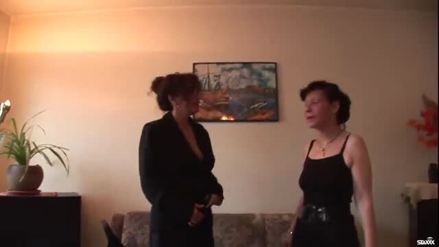 Two mature hookers in sexy black outfits chatting intimately