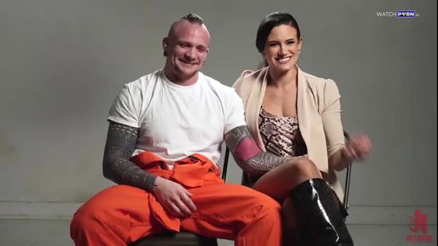 Penny Barber with tattooed inmate in orange jumpsuit, teasing interview